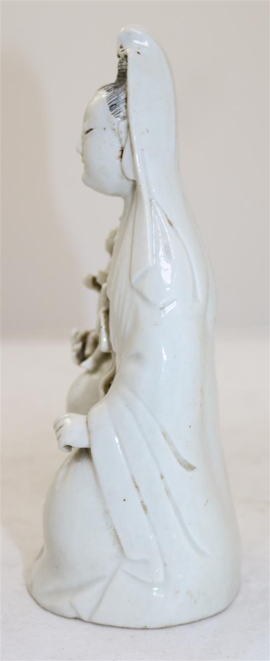 Chinese white glazed porcelain figure of Guanyin holding a child, Jiaqing period, 21cm, childs head re-stuck(-)